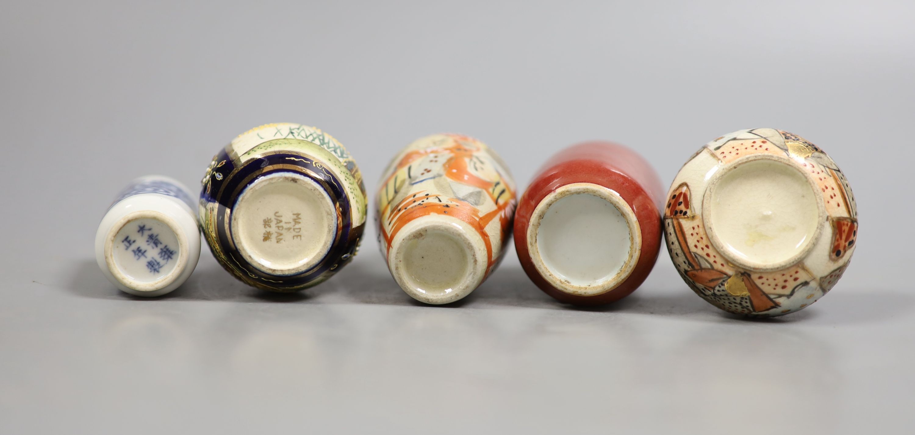 A group of five small Chinese porcelain and Japanese pottery vases, tallest 9.5 cm